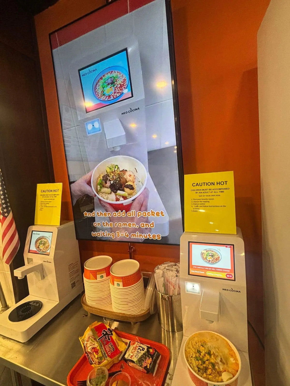 NEO CUCINA self-serve ramen station installed inside a banh mi shop with touchscreen ramen cookers and ramen display