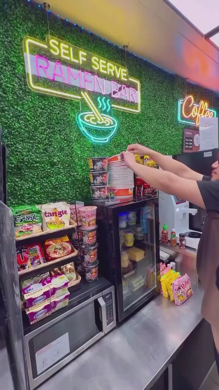 Customer making a bowl of ramen at a self-serve station in a Santa Ana gas station