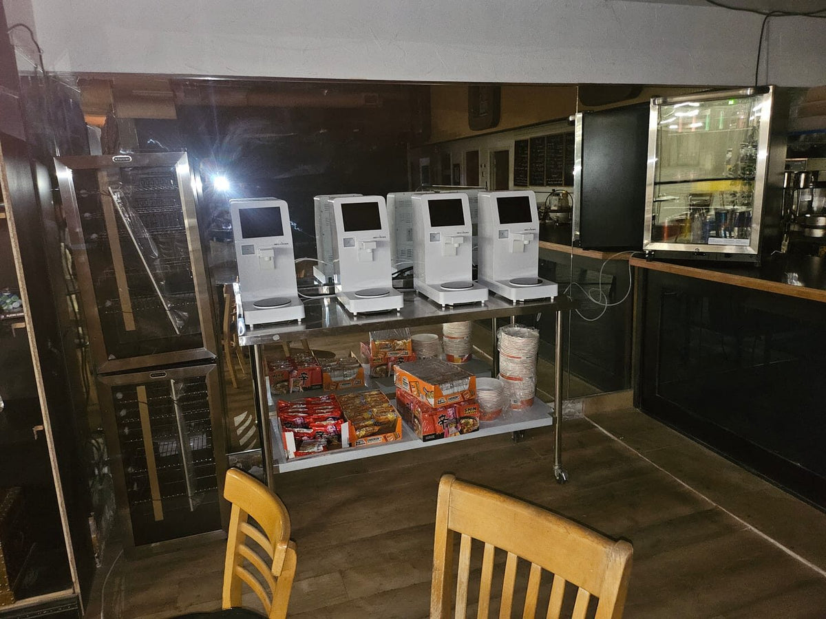 Four NEO CUCINA Pro machines on a rolling cart at an escape room in Albuquerque