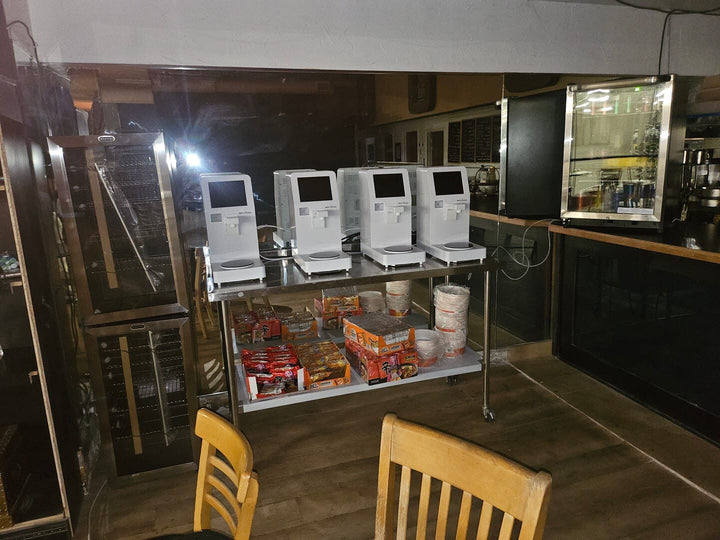 Four NEO CUCINA machines on a rolling cart at an escape room in Albuquerque, New Mexico