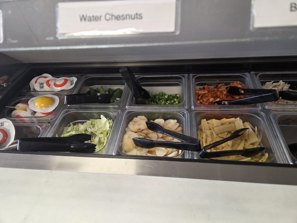 Chilled ramen topping bar with eggs, kimchi and vegetables