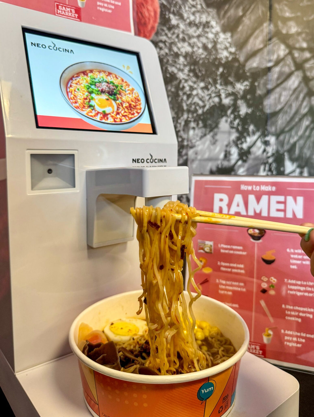 Noodles lifted from a fresh bowl at a campus ramen station