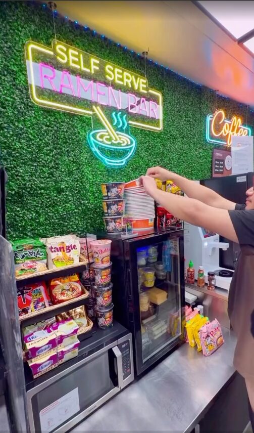 Self-serve ramen bar with neon sign inside a gas station store in Santa Ana, California
