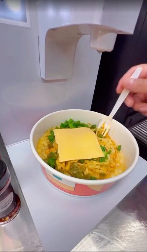 Fresh ramen topped with cheese and green onion at a gas station ramen bar in Santa Ana
